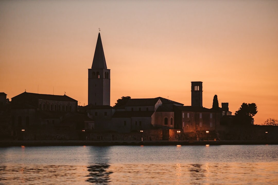 Rovinj old town peninsula with bell tower at sunset