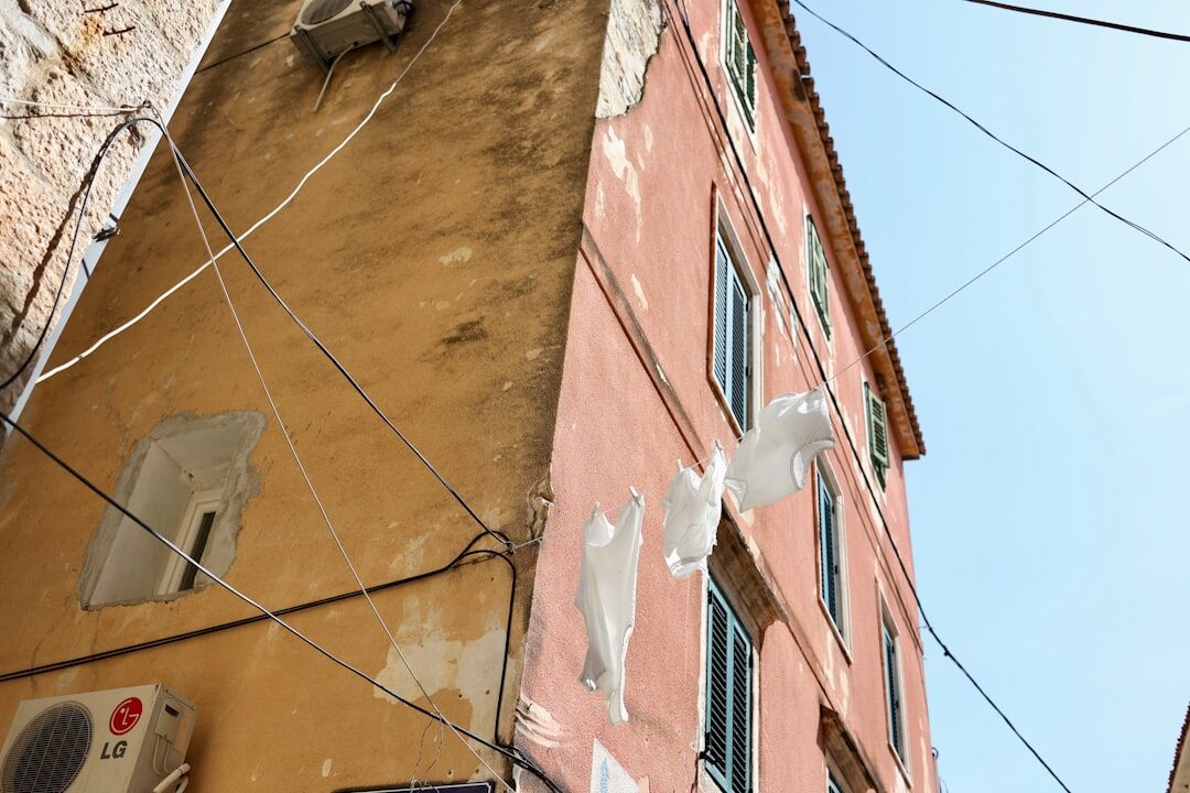 Young Croatian artist painting a mural on scaffolding