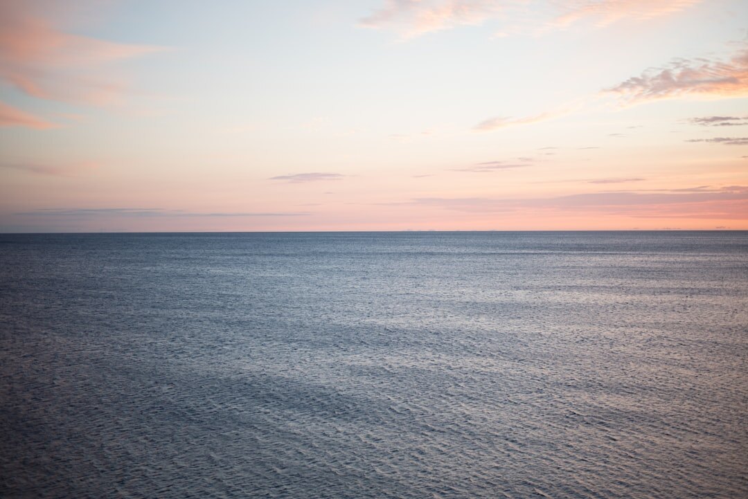 Calm Adriatic Sea at sunrise with a lone fishing boat