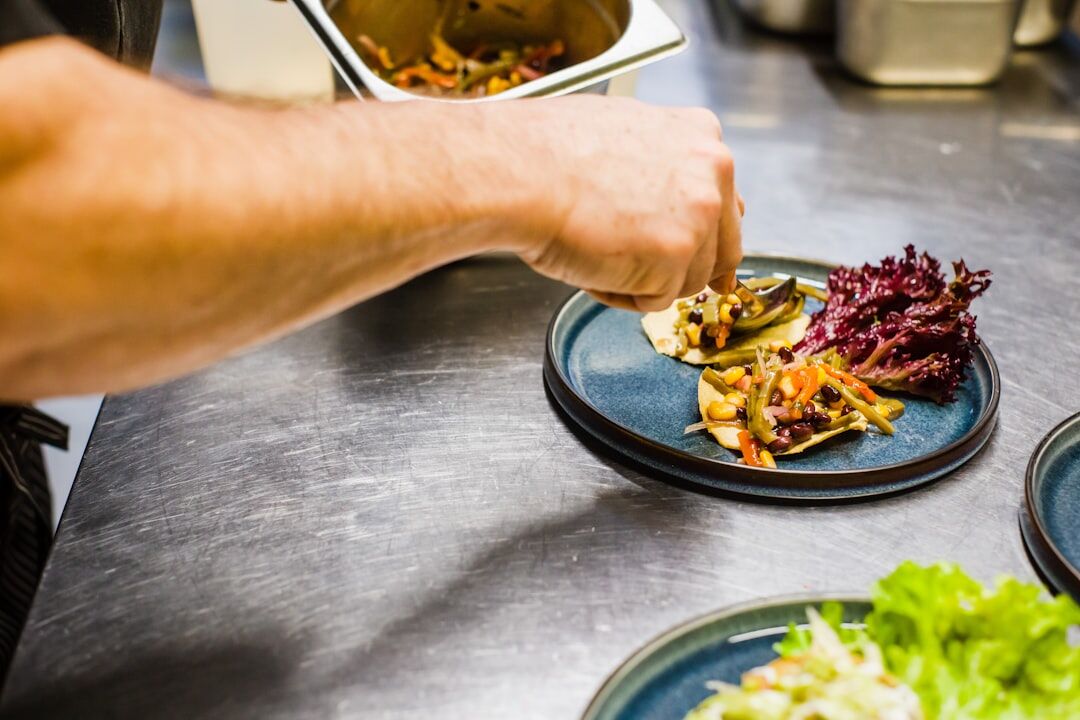 Chef plating seafood at a Croatian coastal restaurant