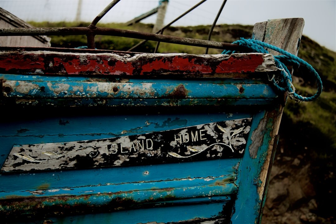 Detail of peeling paint on a wooden fishing boat hull